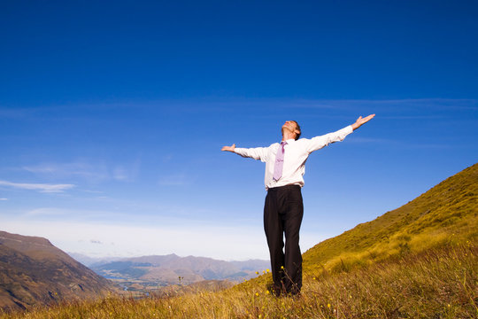 Business Man Standing On The Mountains