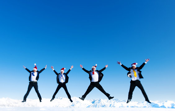 Businessmen Celebrating Christmas on Snow Covered Mountain