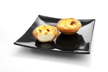 Egg tarts on black plate