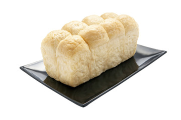 Fresh soft bread on black plate isolated
