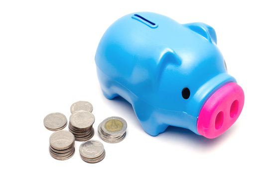 Blue piggy bank or money box and coins on white background.
