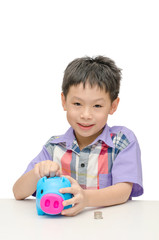 Asian smiling boy with piggy bank isolated on white