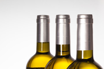 Detail of three wine bottle on white  background.