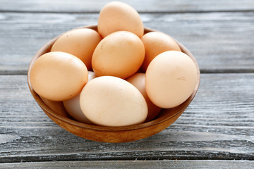 Eggs in a bowl on wooden boards