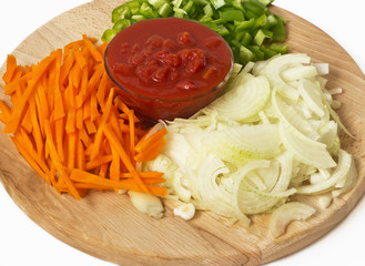 Carrot, onion and peppers on a cutting board