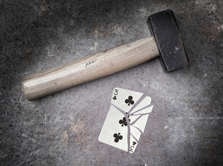 Hammer with a broken card, three of clubs