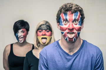 Funny people with European flags on faces