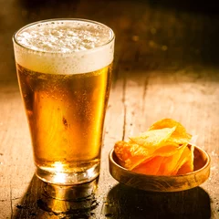 Fototapeten Glass of refreshing cold beer with crisps © exclusive-design