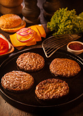 Preparing burgers with cheese and patties