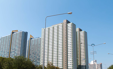 Towering high-rise residential building under the blue sky