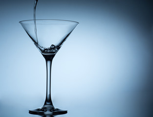cocktail pouring in martini glasses
