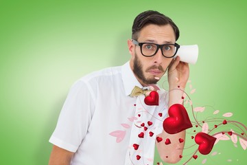 Composite image of geeky businessman eavesdropping with cup