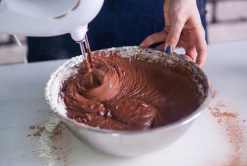 Mixing  egg cream in bowl with motor mixer, baking cake