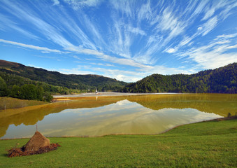Abandoned church in the middle of a red polluted lake full with mining residuals in Romania, Alba, Geamana