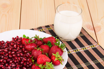 Fresh strawberries with pomegranate grains.