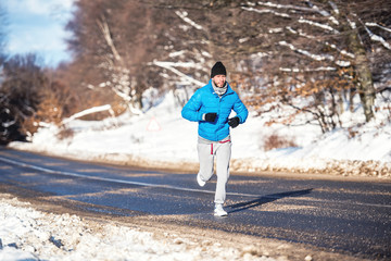 Active man, jogging and running during a sunny winter day