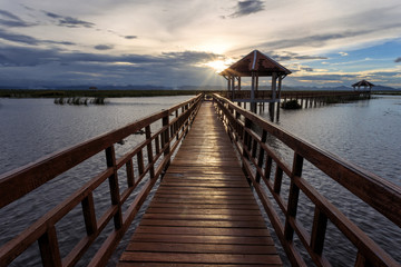 Fototapeta premium The long bridge over the sea with a beautiful sunrise, Thailand
