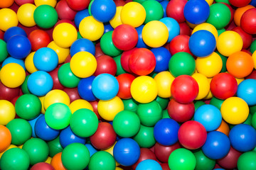 many  colorful plastic balls in the pool for children