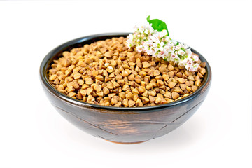 Buckwheat in brown bowl and flower