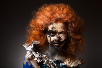 Beautiful sensual woman with long red hairs and face art