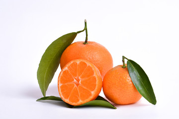 Oranges and mandarin cut in half slice and green leaves