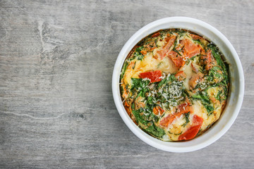 An oven omelette with baby spinach and tomatoes