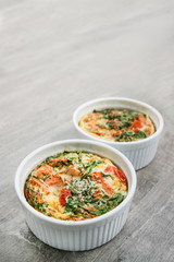 An oven omelette with baby spinach and tomatoes
