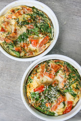 An oven omelette with baby spinach and tomatoes
