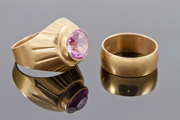 gold ring with a precious stone and old broad engagement ring