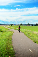 Bicycle, green fields and small village