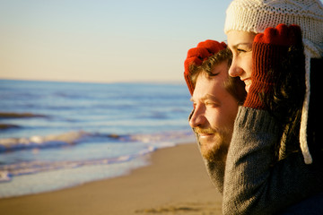 Closeup of handsome couple watching the sea in winter