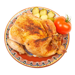 Fried chicken on a plate with pickles on a white background