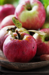 Fresh red apples on the wooden table, selective focus