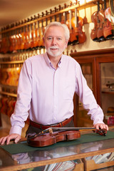 Portrait Of Violin Maker In Shop