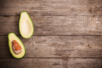 Ripe avocado on a wooden background