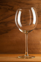 Glass of wine on the wooden background