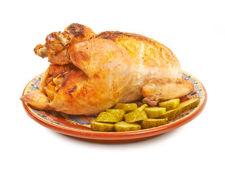 Fried chicken on a plate with pickles on a white