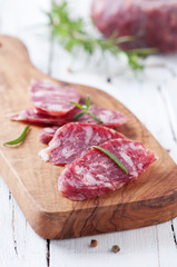 Fresh italian sausage on the wooden table, selective focus