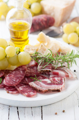 Italian antipasto with sausage, cheese and grapes,