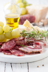 Italian antipasto with sausage, cheese and grapes,