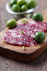 Fresh italian sausage on the wooden table, selective focus