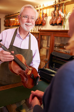 Customer Leaving Violin For Repair In Shop