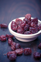 dried cranberries in a wooden spoon. fruit full of vitamin c. 