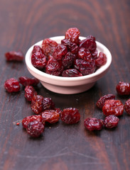 dried cranberries in a wooden spoon. fruit full of vitamin c. 