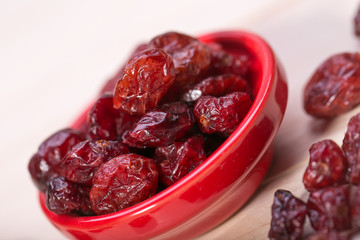 dried cranberries in a wooden spoon. fruit full of vitamin c.
