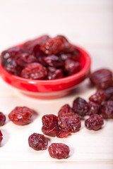 dried cranberries in a wooden spoon. fruit full of vitamin c.