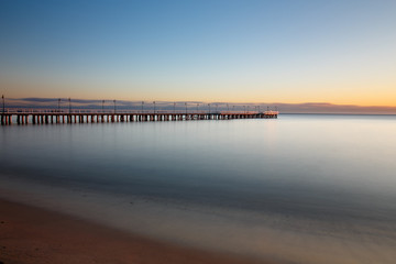 Fototapeta premium Beautiful colorful Sunrise on the pier at the seaside