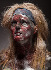 woman in silver paint and red powder