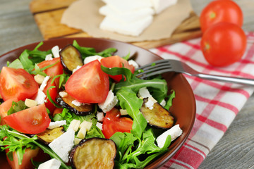 Eggplant salad with tomatoes, arugula and feta cheese,
