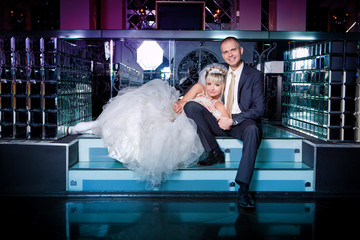 Beautiful young bride and groom next to bar